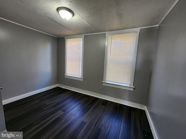 unfurnished room with a textured ceiling and dark wood-type flooring