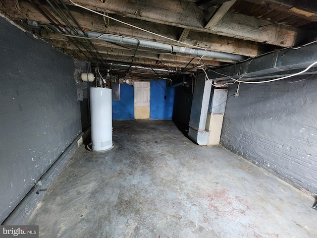 basement featuring gas water heater, electric panel, and heating unit