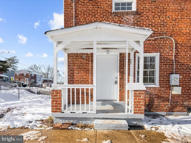 view of snow covered property entrance