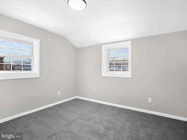 bonus room with carpet floors and vaulted ceiling