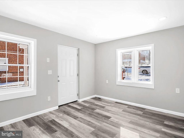 empty room with hardwood / wood-style floors