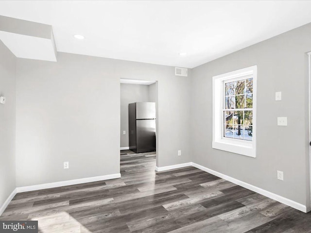 empty room featuring dark hardwood / wood-style flooring