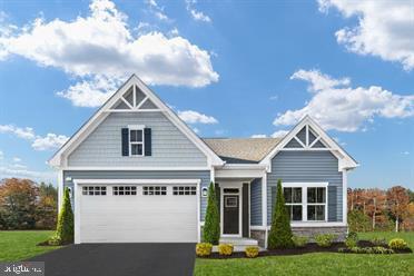 craftsman-style home with a garage and a front lawn