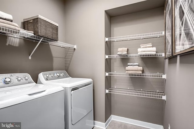 laundry area with tile patterned floors and washer and dryer