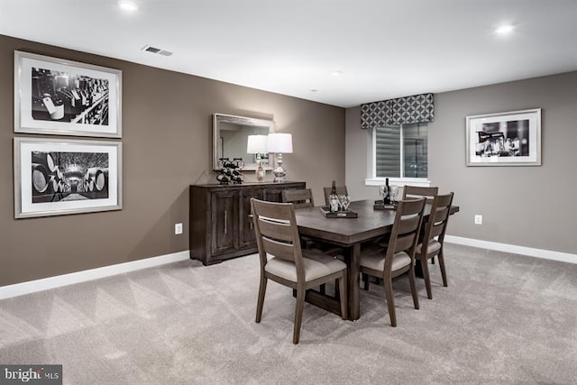 dining room featuring light colored carpet