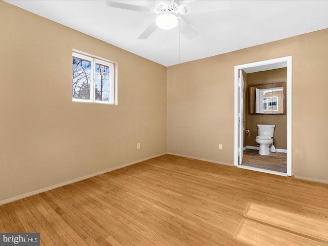 unfurnished bedroom with ceiling fan, light hardwood / wood-style floors, and connected bathroom