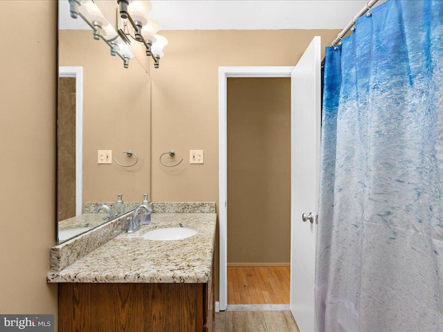 bathroom with hardwood / wood-style floors and vanity