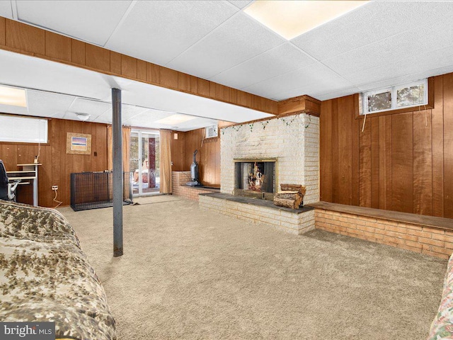 interior space featuring an AC wall unit, wood walls, and a fireplace