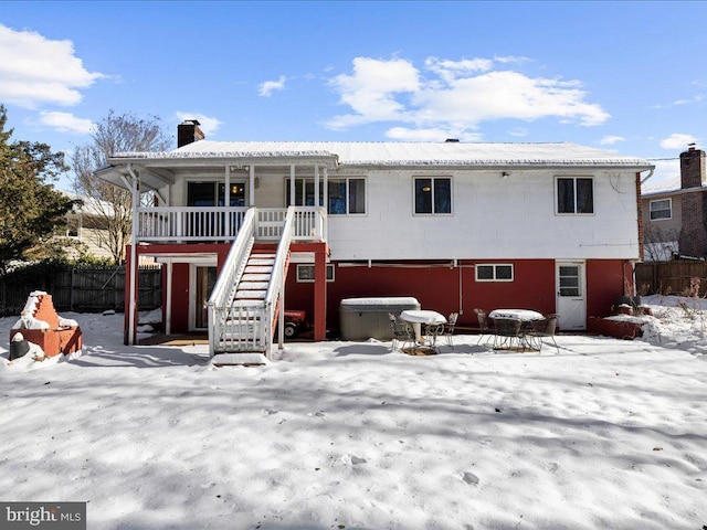 view of snow covered back of property