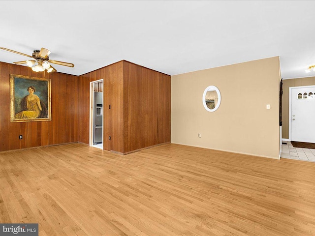 unfurnished living room featuring ceiling fan and light hardwood / wood-style floors