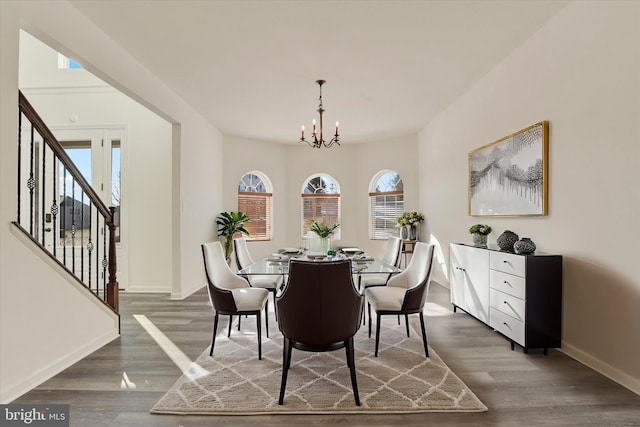 dining space featuring a chandelier, dark hardwood / wood-style flooring, and a healthy amount of sunlight