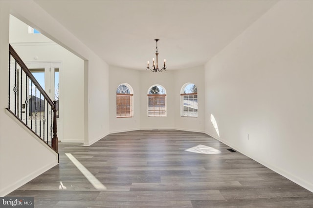 interior space featuring a chandelier and dark wood-type flooring