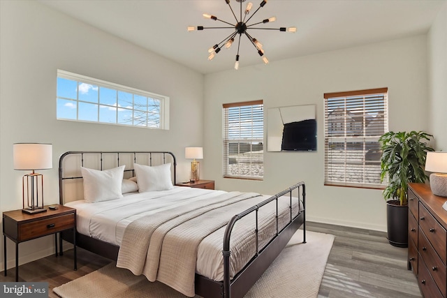 bedroom featuring hardwood / wood-style flooring and an inviting chandelier