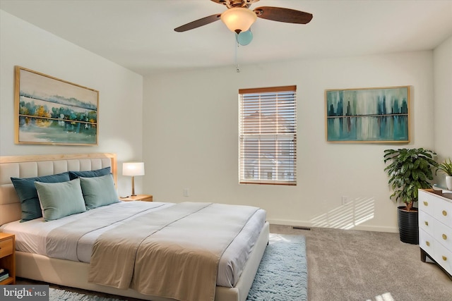 bedroom with ceiling fan and light colored carpet