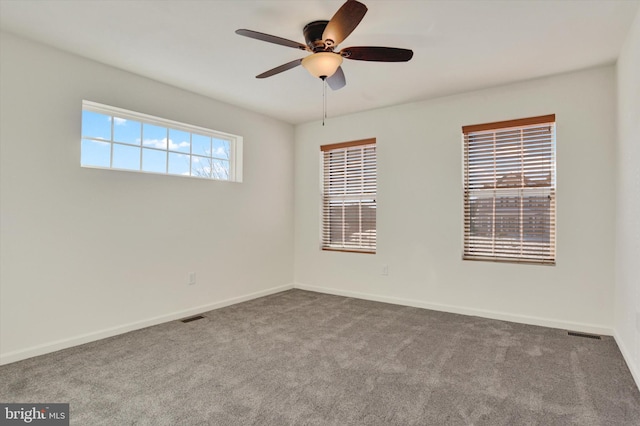 carpeted empty room featuring ceiling fan