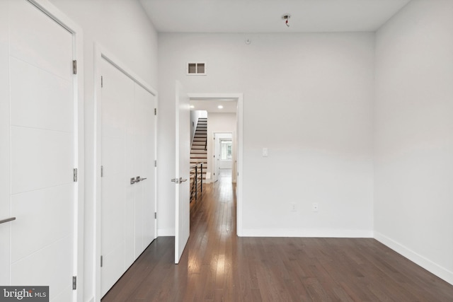 hall with dark wood-type flooring