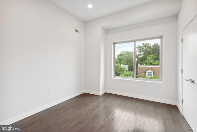 unfurnished room featuring dark hardwood / wood-style flooring