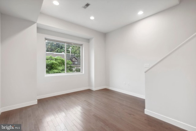 empty room with dark hardwood / wood-style flooring