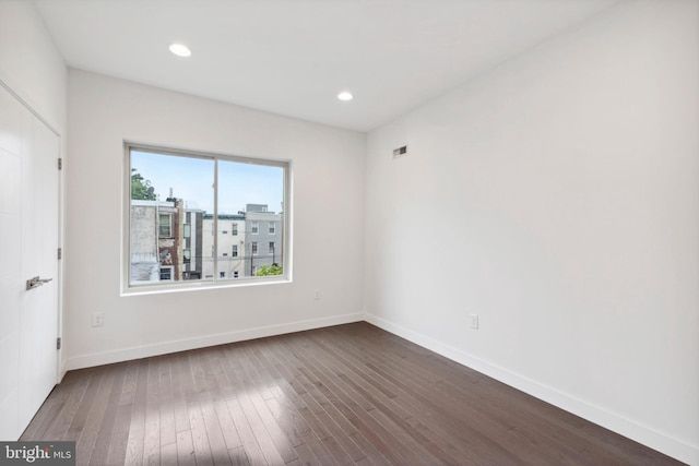 spare room with wood-type flooring