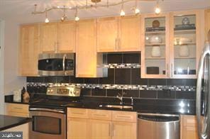 kitchen featuring sink, light brown cabinetry, and appliances with stainless steel finishes