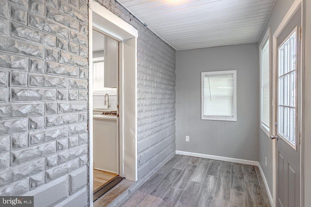 unfurnished room featuring sink and hardwood / wood-style flooring