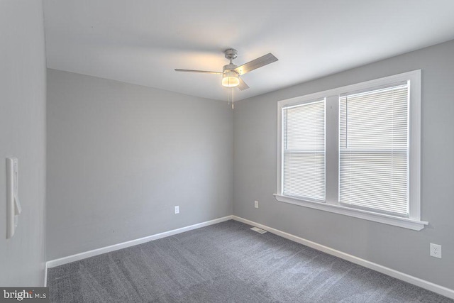 carpeted empty room featuring ceiling fan