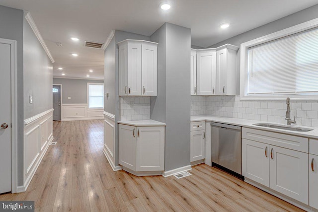 kitchen featuring dishwasher, white cabinetry, and sink