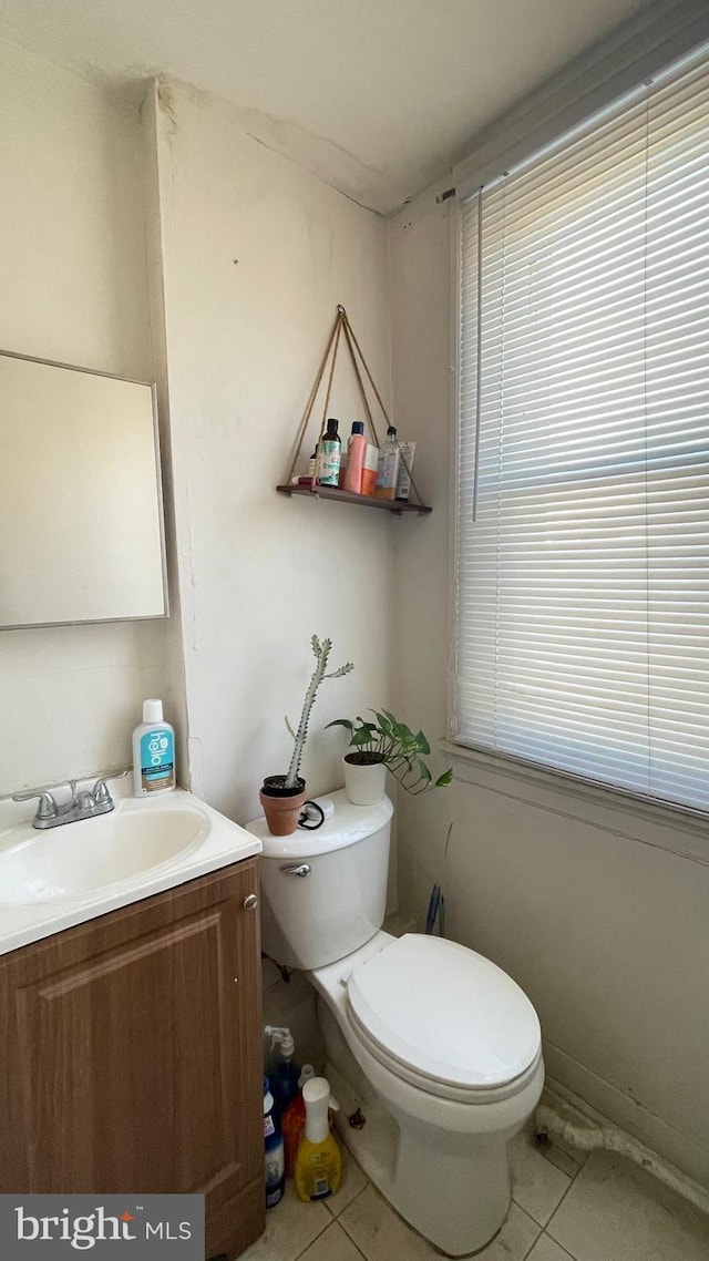 bathroom with tile patterned floors, toilet, and vanity