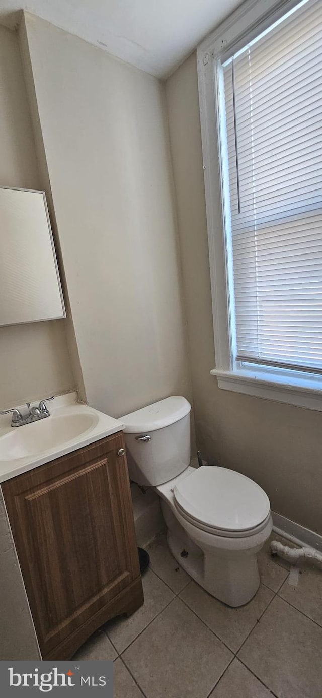 bathroom with tile patterned floors, vanity, and toilet