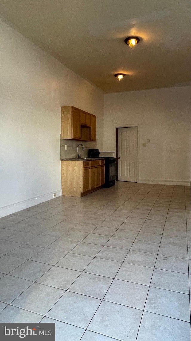 kitchen with light tile patterned floors and sink