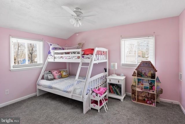 carpeted bedroom with a textured ceiling, ceiling fan, and vaulted ceiling