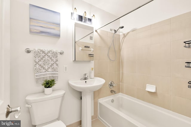 full bathroom featuring sink, toilet, and tiled shower / bath