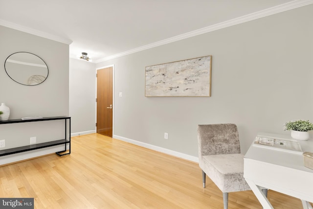 living area featuring crown molding and hardwood / wood-style flooring