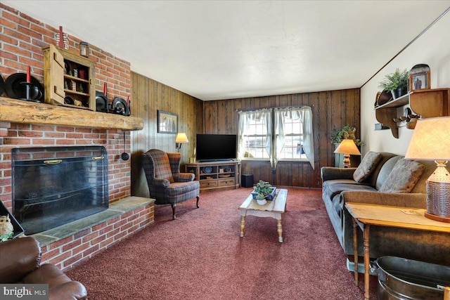 living room featuring carpet floors, wooden walls, and a brick fireplace