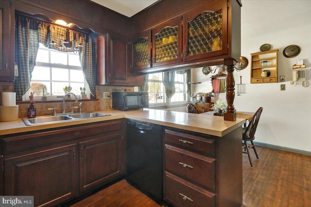 kitchen featuring kitchen peninsula, dark hardwood / wood-style flooring, dark brown cabinets, sink, and black appliances