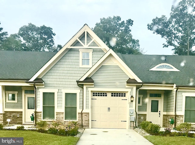 view of front of house with a garage and a front lawn