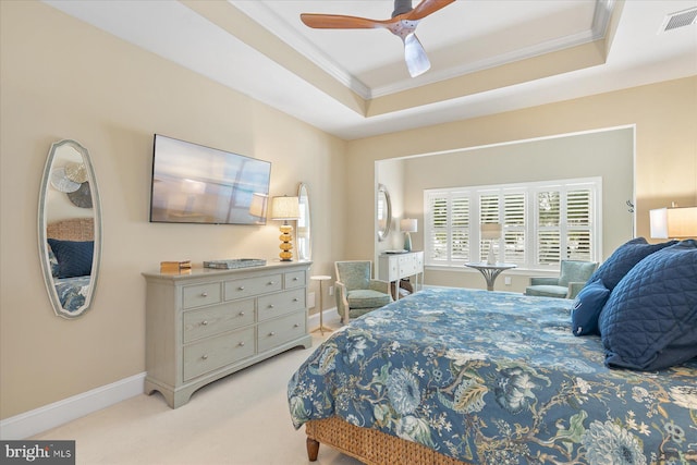 bedroom with crown molding, ceiling fan, a raised ceiling, and light carpet