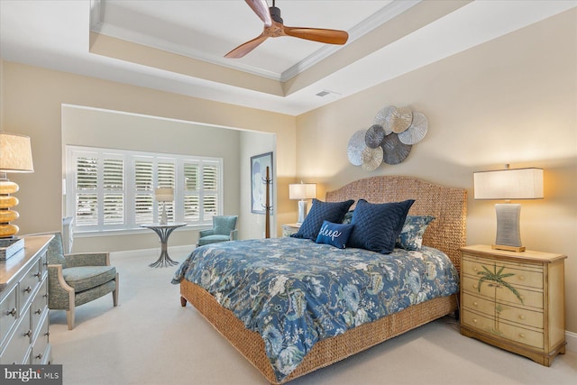 bedroom featuring crown molding, light colored carpet, a raised ceiling, and ceiling fan