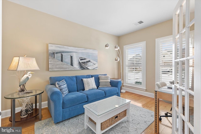 living room with french doors and wood-type flooring