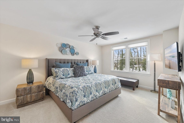 bedroom featuring light carpet and ceiling fan