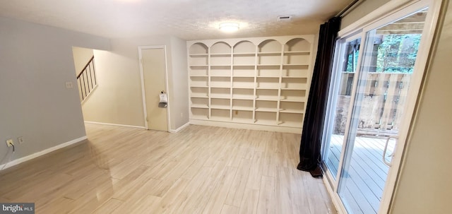 3625 Silver Spruce Cir, Burtonsville, MD 20866 - spare room featuring light wood-style floors, stairway, and a textured ceiling