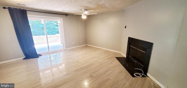3625 Silver Spruce Cir, Burtonsville, MD 20866 - unfurnished living room with a textured ceiling, a ceiling fan, wood finished floors, and a fireplace with flush hearth