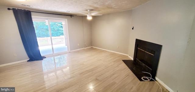 3625 Silver Spruce Cir, Burtonsville, MD 20866 - unfurnished living room with a ceiling fan, wood finished floors, a textured ceiling, and a fireplace with flush hearth