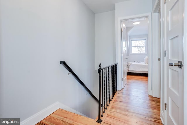 staircase with hardwood / wood-style floors