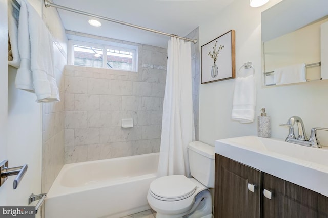 full bathroom featuring vanity, shower / bath combination with curtain, and toilet