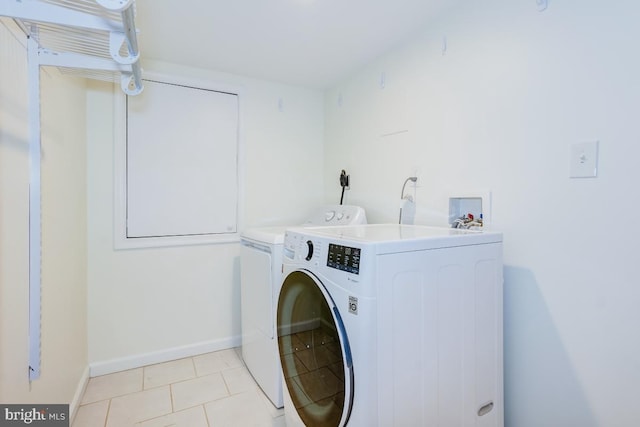 laundry room featuring light tile patterned floors and washer and clothes dryer