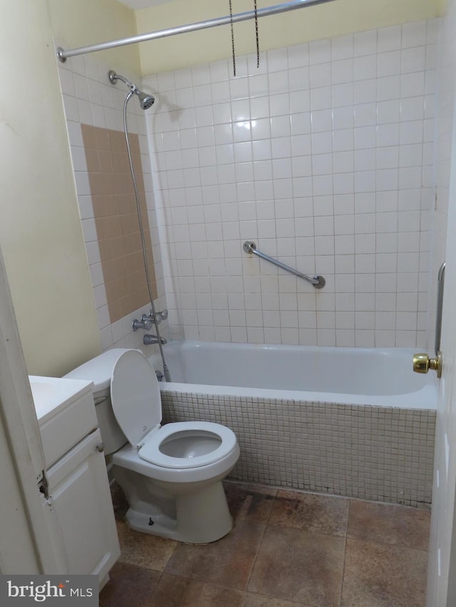 full bathroom featuring vanity, toilet, and tiled shower / bath