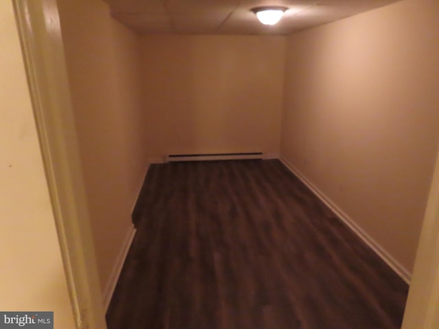 interior space with a baseboard radiator and dark wood-type flooring