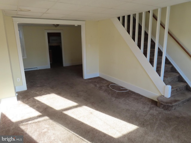 staircase with carpet and a drop ceiling