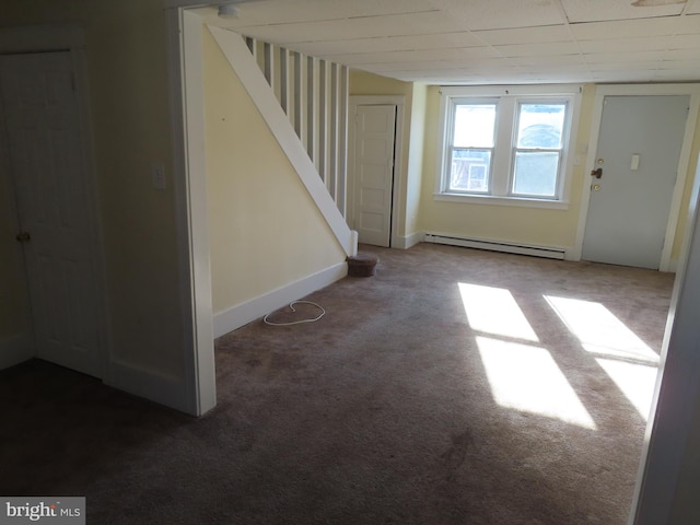 interior space with a paneled ceiling, carpet floors, and baseboard heating